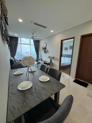 a dining table and chairs in a living room at Nest In The Sky in Kuala Lumpur