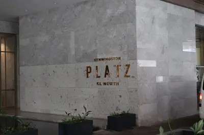 a sign on the side of a building with plants at COZY Kenwingston platz KL 2-5PAX Klcc View Pakin Nefix Free parkin 1807 in Kuala Lumpur
