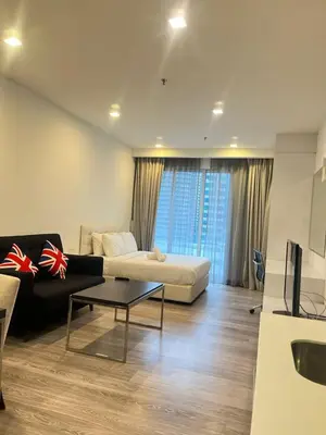 a living room with a couch and a table at Flexy Suite at One Bukit Ceylon Bukit Bintang in Kuala Lumpur