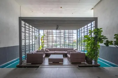 a living room with a couch and a large window at Flexy Suite at One Bukit Ceylon Bukit Bintang in Kuala Lumpur