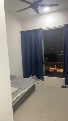 a bedroom with a bed and a ceiling fan at The Nest Service Apartment in Kuala Lumpur