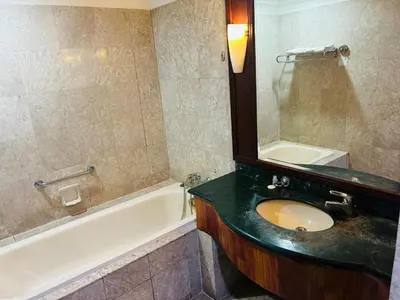 a bathroom with a sink and a tub and a mirror at My Residence suite at Berjaya times square Kl in Kuala Lumpur