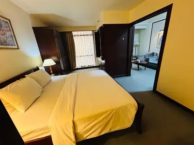 a bedroom with a large bed and a living room at My Residence suite at Berjaya times square Kl in Kuala Lumpur