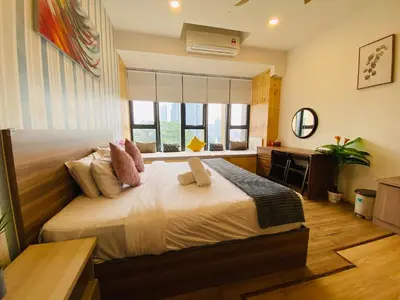a bedroom with a large bed and a window at Ceylonz Suites by Stayla in Kuala Lumpur