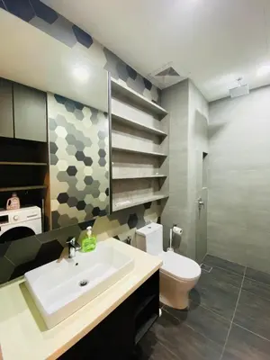 a bathroom with a sink and a toilet at Ceylonz Suites by Stayla in Kuala Lumpur