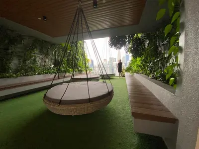 two swings on a balcony with green grass at Ceylonz Suites by Stayla in Kuala Lumpur