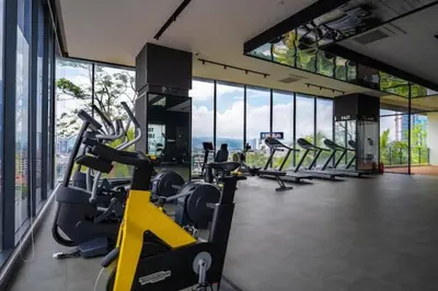 a gym with rows of exercise bikes in a building at Muji Studio Continew by RumaBnB in Kuala Lumpur
