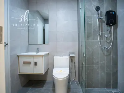a bathroom with a shower and a toilet and a sink at Majestic Residence - Central KL Stay with Petronas Twin Towers View Sky Pool by The Stay Hub in Kuala Lumpur