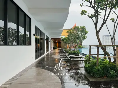 a lobby with benches and a view of the water at Majestic Residence - Central KL Stay with Petronas Twin Towers View Sky Pool by The Stay Hub in Kuala Lumpur