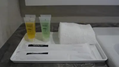 a tray with two cups and a thermometer and a towel at Manor Residence KLCC - LV Home in Kuala Lumpur