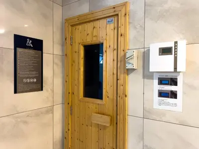 a wooden door in a wall with a sign at Manor Residence KLCC - LV Home in Kuala Lumpur