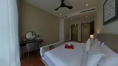 a bedroom with a large white bed and a mirror at Manor Residence KLCC - LV Home in Kuala Lumpur