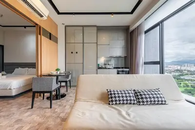 a living room with a couch and a bedroom at KLCC Expressionz Couple Suites 1B1B in Kuala Lumpur
