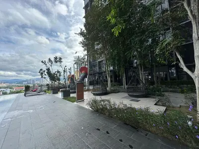 a park with benches and trees and a building at KLCC Expressionz Couple Suites 1B1B in Kuala Lumpur