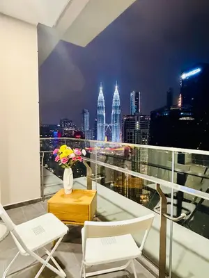 a balcony with chairs and a view of the city at SS Luxury Suites AT TM Persiaran Stonor KLCC in Kuala Lumpur