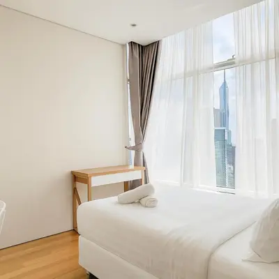 a bedroom with a white bed and a window at Sky Suites KLCC - Luxury Service Apartments Near Petronas Twin Tower in Kuala Lumpur