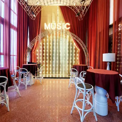 a room with red curtains and tables and chairs at Scarletz Villa Near By KLCC in Kuala Lumpur