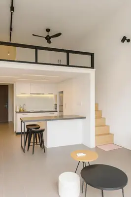 a kitchen and living room with tables and chairs at Mindful Bangsar Loft KL Sentral Mid Valley The Gardens Pasar Seni in Kuala Lumpur