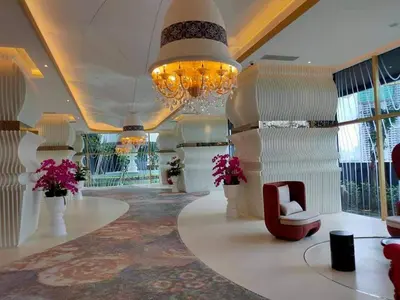 a large lobby with a chandelier and a chair at ARTE Mont Kiara Designer Suites by HOST CORNER in Kuala Lumpur