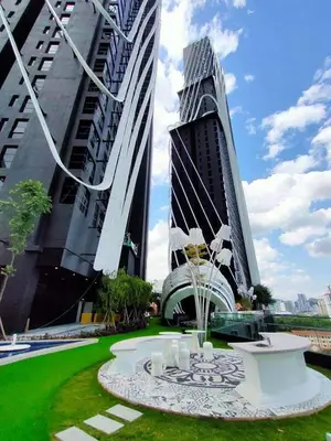 a park with two tall buildings and a fountain at ARTE Mont Kiara Designer Suites by HOST CORNER in Kuala Lumpur