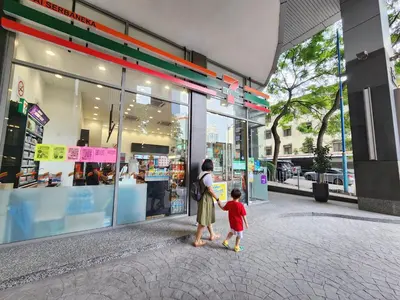 a woman and a child standing outside of a store at KL Penthouse Skyline View in Bukit Bintang Fairlane in Kuala Lumpur