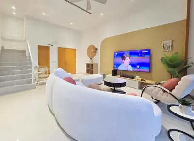 a living room with white furniture and a flat screen tv at KL Penthouse Skyline View in Bukit Bintang Fairlane in Kuala Lumpur