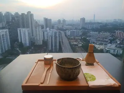 a wooden tray with a bowl and utensils on a table at Kiaramas Gateway Residence in Kuala Lumpur