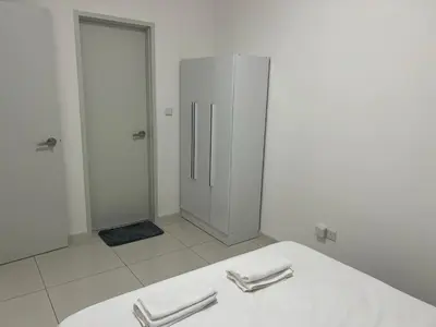a white bathroom with a mirror and a towel rack at MAJESTIC RESlDENCE KLCC in Kuala Lumpur