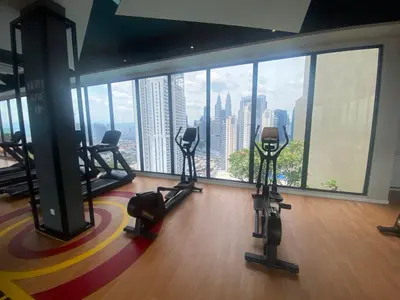 a gym with a view of a city skyline at MAJESTIC RESlDENCE KLCC in Kuala Lumpur