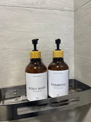 two bottles of body wash sitting on a shelf at Arte Ampang KLCC 2 BR Homestay, 4-6 pax in Ampang