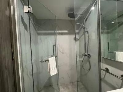 a bathroom with a shower with a glass door at Deluxe Duplex Studio Suite at Agile Bukit Bintang in Kuala Lumpur