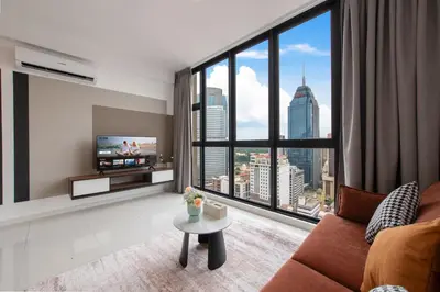 a living room with a couch and a large window at Majestic by Avery at KLCC#Located in the City Center#10 mins Walk to Twin Towers#Rooftop Infinity pool#\u4e2d\u82f1\u6587\u623f\u4e1c in Kuala Lumpur