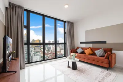 a living room with a couch and a large window at Majestic by Avery at KLCC#Located in the City Center#10 mins Walk to Twin Towers#Rooftop Infinity pool#\u4e2d\u82f1\u6587\u623f\u4e1c in Kuala Lumpur