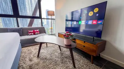 a living room with a tv and a couch at Scarletz Suite KLCC By Light House 3 in Kuala Lumpur