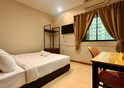 a bedroom with a bed and a table and a window at Swing & Pillows - Chow Kit Road, Kuala Lumpur in Kuala Lumpur
