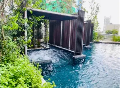 a pool of water with a fence and trees at Stay At KL 4 pax at Bukit Bintang KL Monorail in Kuala Lumpur