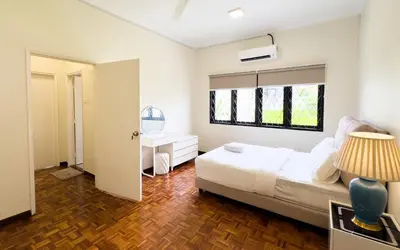 a bedroom with a bed and a desk and a window at Damansara Heights Luxury Villa with Private Pool in Kuala Lumpur