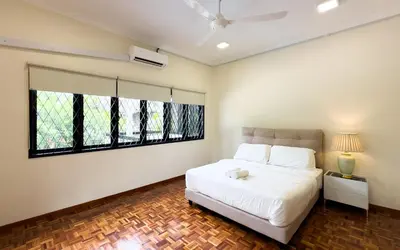 a bedroom with a white bed and a large window at Damansara Heights Luxury Villa with Private Pool in Kuala Lumpur