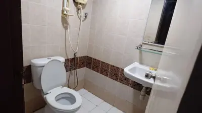 a bathroom with a toilet and a sink at Hotel Wings Kuala Lumpur in Kuala Lumpur