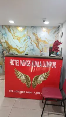 a red wall with a hotel wings kuala lumpur sign at Hotel Wings Kuala Lumpur in Kuala Lumpur