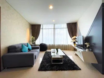 a living room with a couch and a tv at The Luxury Penthouse KLCC in Kuala Lumpur