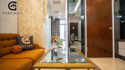 a living room with a couch and a glass table at Dorsett Residences Bukit Bintang by Guestonic in Kuala Lumpur