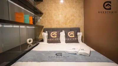 a room with a bed with towels on it at Dorsett Residences Bukit Bintang by Guestonic in Kuala Lumpur