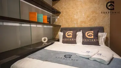 a bed with two pillows on top of it at Dorsett Residences Bukit Bintang by Guestonic in Kuala Lumpur