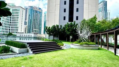 a park in a city with tall buildings at Visitors Axon Residence Bukit Bintang KL City Center in Kuala Lumpur