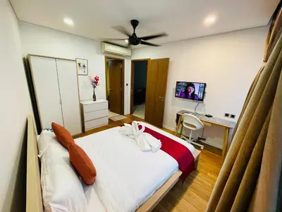 a bedroom with a bed and a desk with a computer at Votrex Suites KLCC By Classic Home in Kuala Lumpur