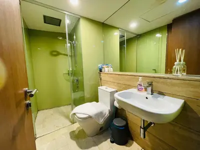a bathroom with a toilet and a sink and a shower at Votrex Suites KLCC By Classic Home in Kuala Lumpur