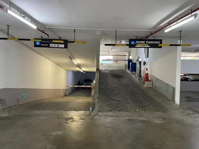 an empty parking lot with a sign in a parking garage at Votrex Suites KLCC By Classic Home in Kuala Lumpur