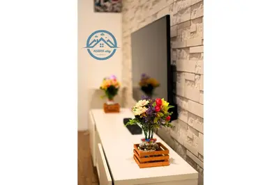 a room with flowers on a table with a mirror at Binjai 8 Premium Soho by Heaven Stay in Kuala Lumpur