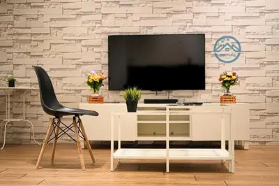 a white desk with a tv and a black chair at Binjai 8 Premium Soho by Heaven Stay in Kuala Lumpur